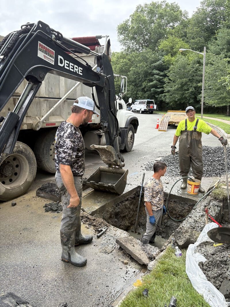 Drain & Sewer Services Excavator and workers at sewer repair site