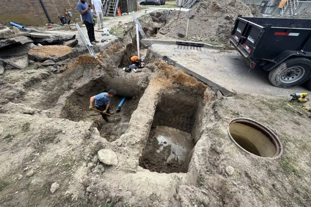 Sewer Line Repair in Medford, NJ | The Sewer Kings Crew working inside a deep trench to access and repair an underground drain line as part of a drain excavation service in Evesham NJ.