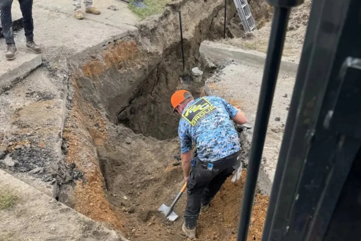Sewer Line Repair in Medford Lakes, NJ Sewer line repair in NJ with technicians excavating a deep trench to expose damaged underground sewer lines.