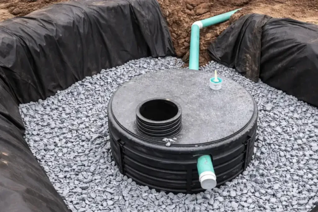 How Septic System Service Is Performed in New Jersey Homes Septic tank set on gravel with inlet and outlet pipes, showing how septic system service and baffle installation are performed in New Jersey homes.