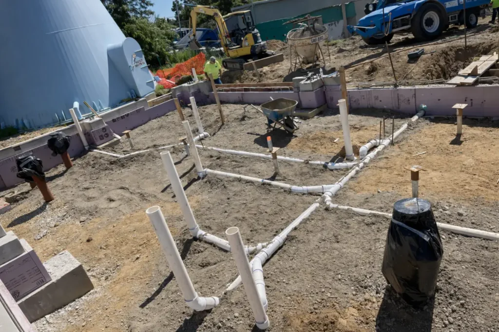 Exposed septic piping and risers during a septic tank baffle repair project at a residential property in Somerdale, NJ.