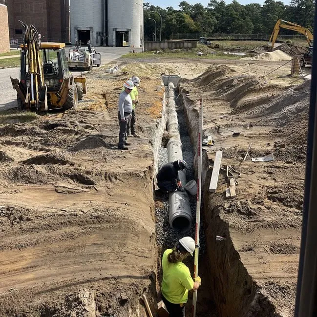 The Sewer Kings crew installing sewer pipes in an excavation trench in South Jersey