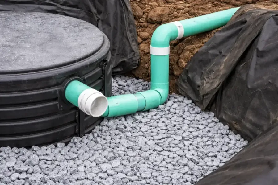 Close-up of septic tank piping connections during a maintenance visit in Evesham, NJ