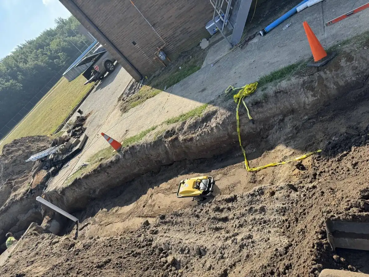 Drain Cleaning near Jackson, Waterford Township, NJ Backfilled drain line trench being compacted near Jackson, Waterford Township, NJ