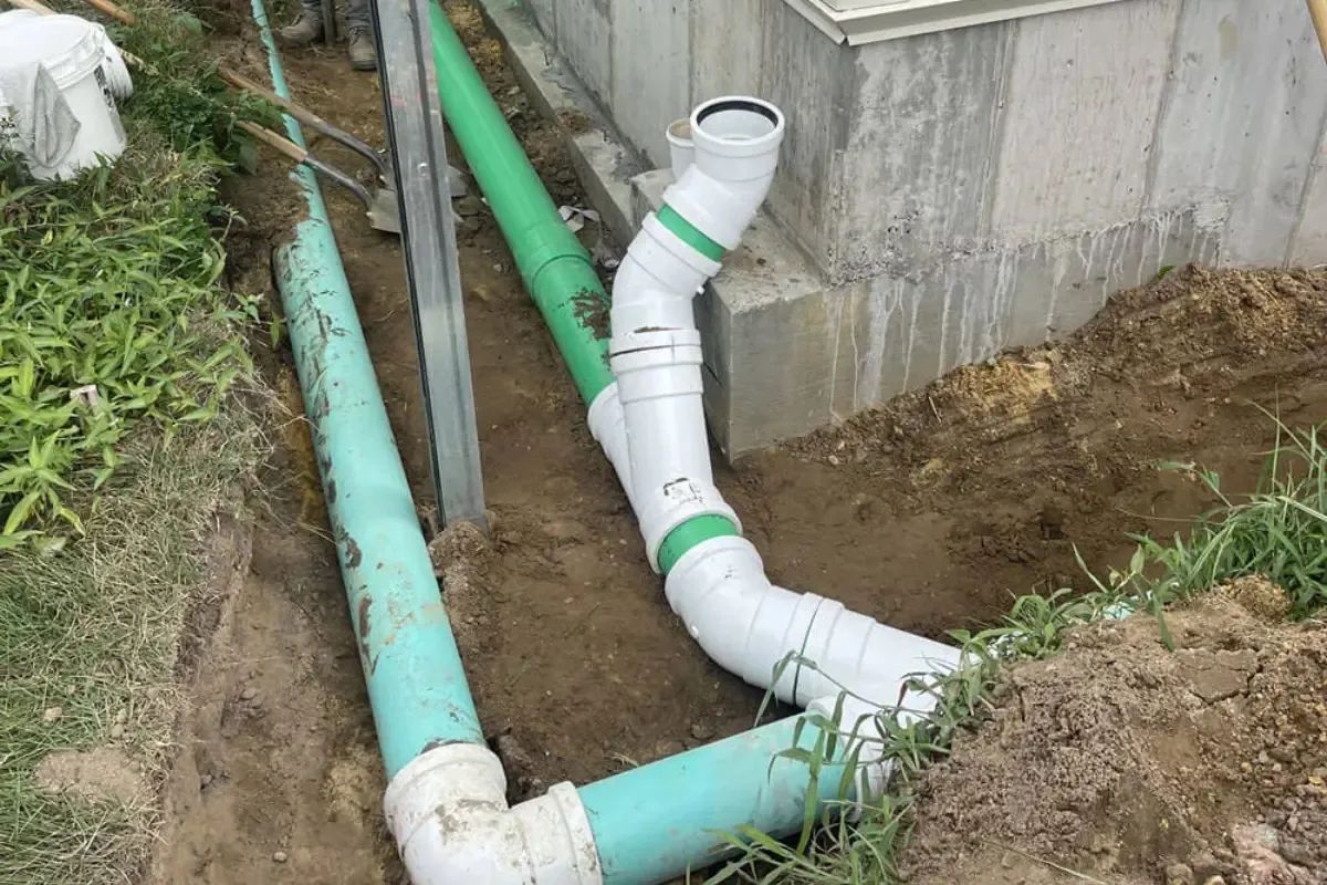 Drain Cleaning near Veterans Avenue Memorial Park, NJ New PVC drain pipe running along a home foundation near Veterans Avenue Memorial Park, NJ