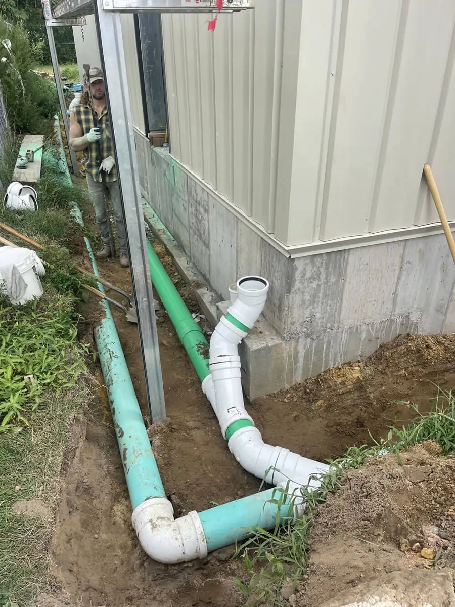 Drain Cleaning near Veteran's Park of Berlin, NJ Downspout tied into a buried PVC drain line beside a house near Veteran's Park of Berlin, NJ