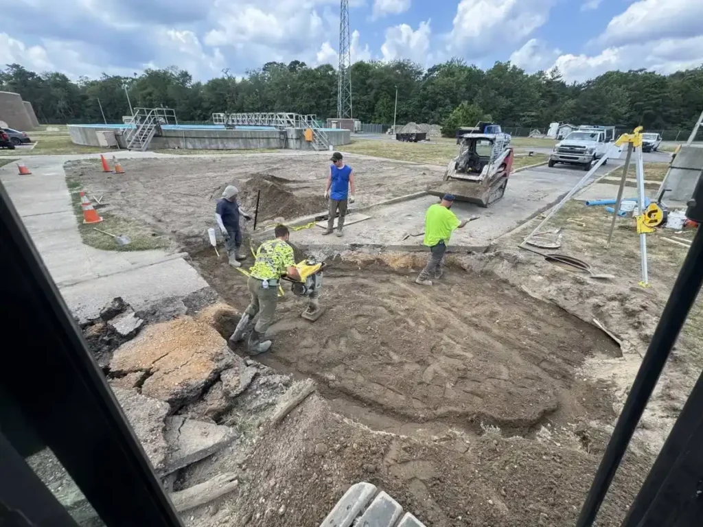 Crew compacting backfill after a drain line repair, root damage fix in Cherry Hill Township, NJ