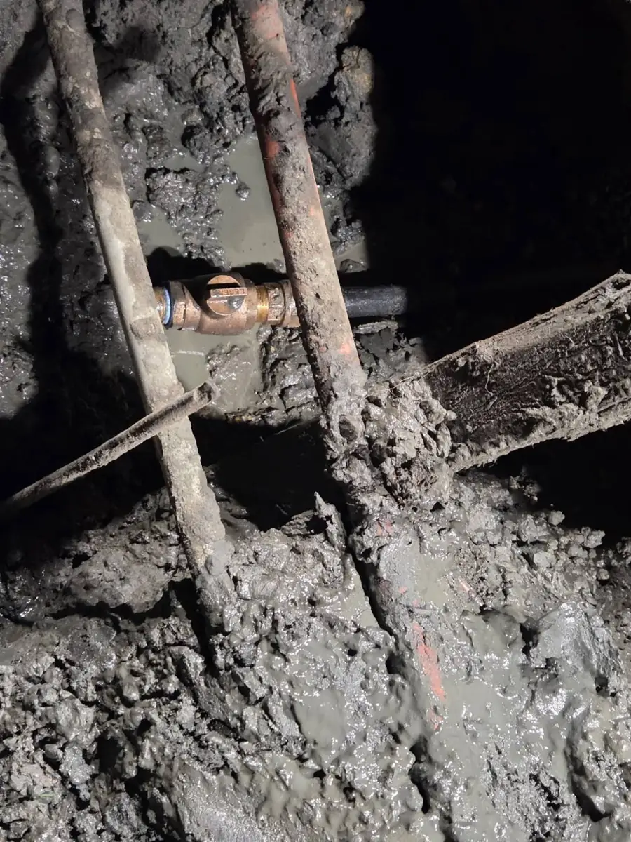 Sewer Line Repair near New Freedom, NJ Buried pipes uncovered in a muddy repair hole near New Freedom, NJ
