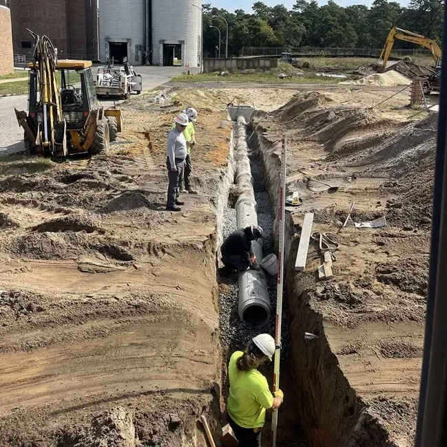 The Sewer Kings crew setting pipe in a deep trench, trenchless sewer line replacement in Cherry Hill Township, NJ