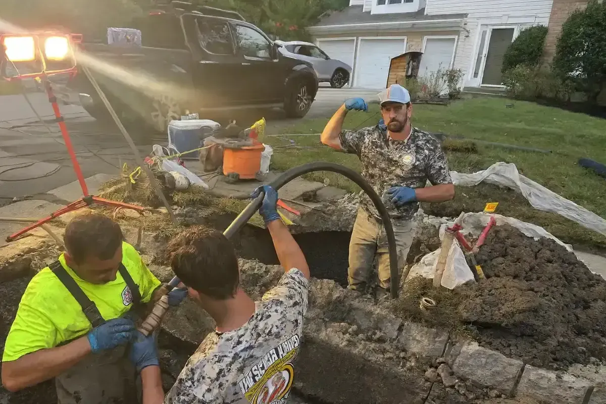 How Do You Get Rid of Drain Flies? The Sewer Kings crew clearing a main drain line with a hose at a South Jersey home