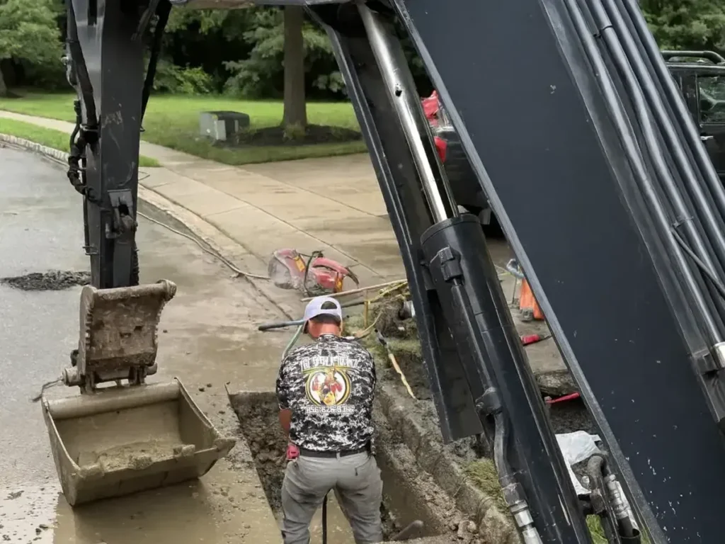 Sewer Kings crew opening the street at a root damaged sewer line in Evesham, NJ after a camera inspection