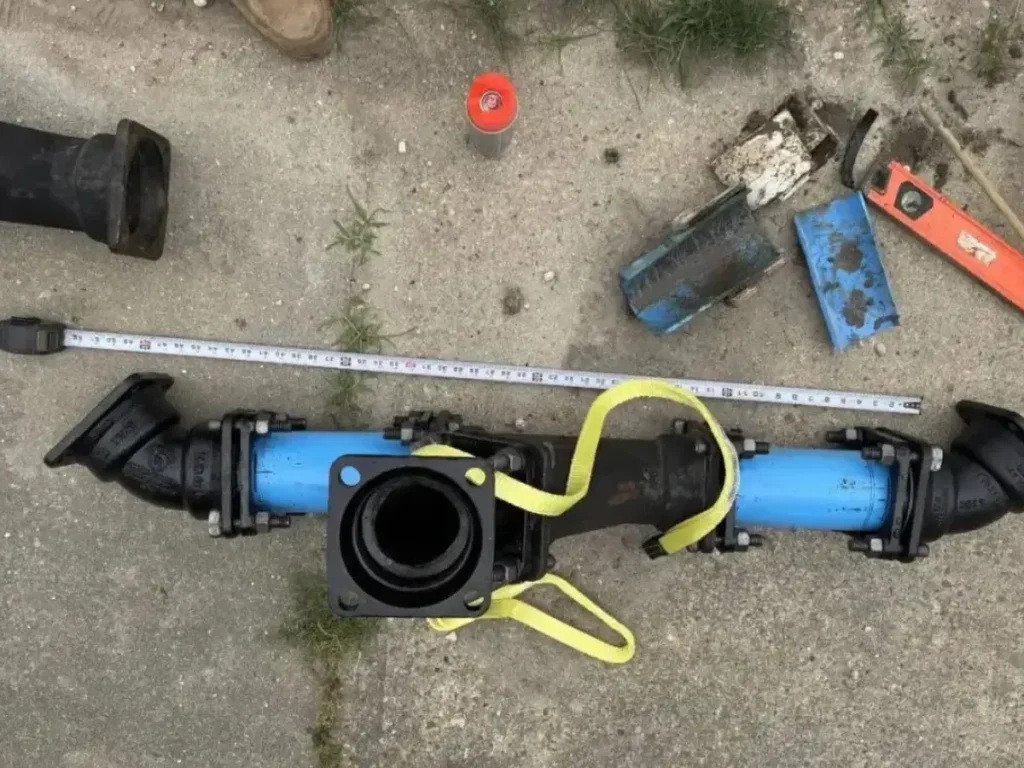 Sewer pipe fitting measured with a tape on a job in Evesham, NJ before a line repair