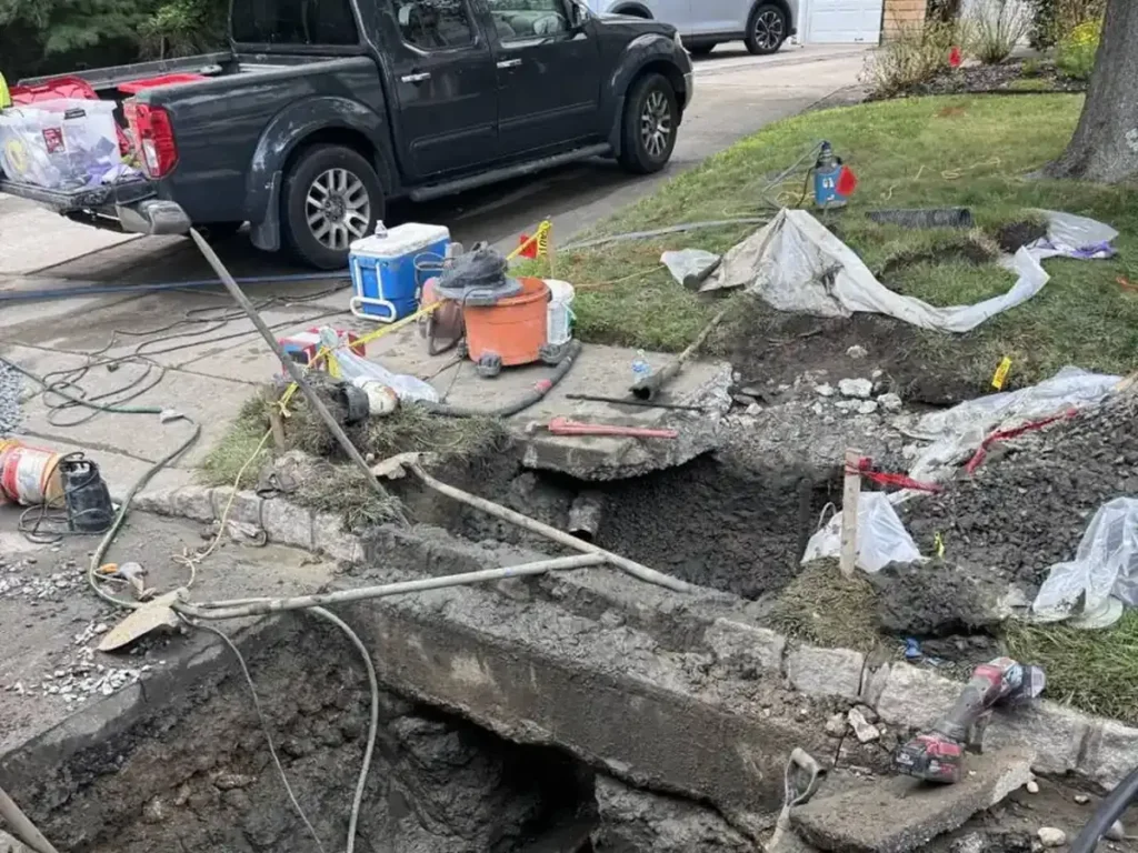 How Long Your Evesham Lawn Takes to Recover After Sewer Line Repair Front lawn cut open for a sewer line repair in Evesham, NJ with turf and spoil set aside on tarps