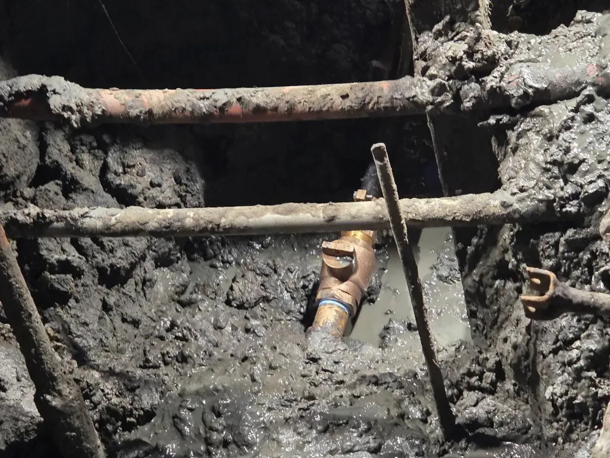 Commercial Old corroded pipes exposed in a muddy sewer excavation in South Jersey