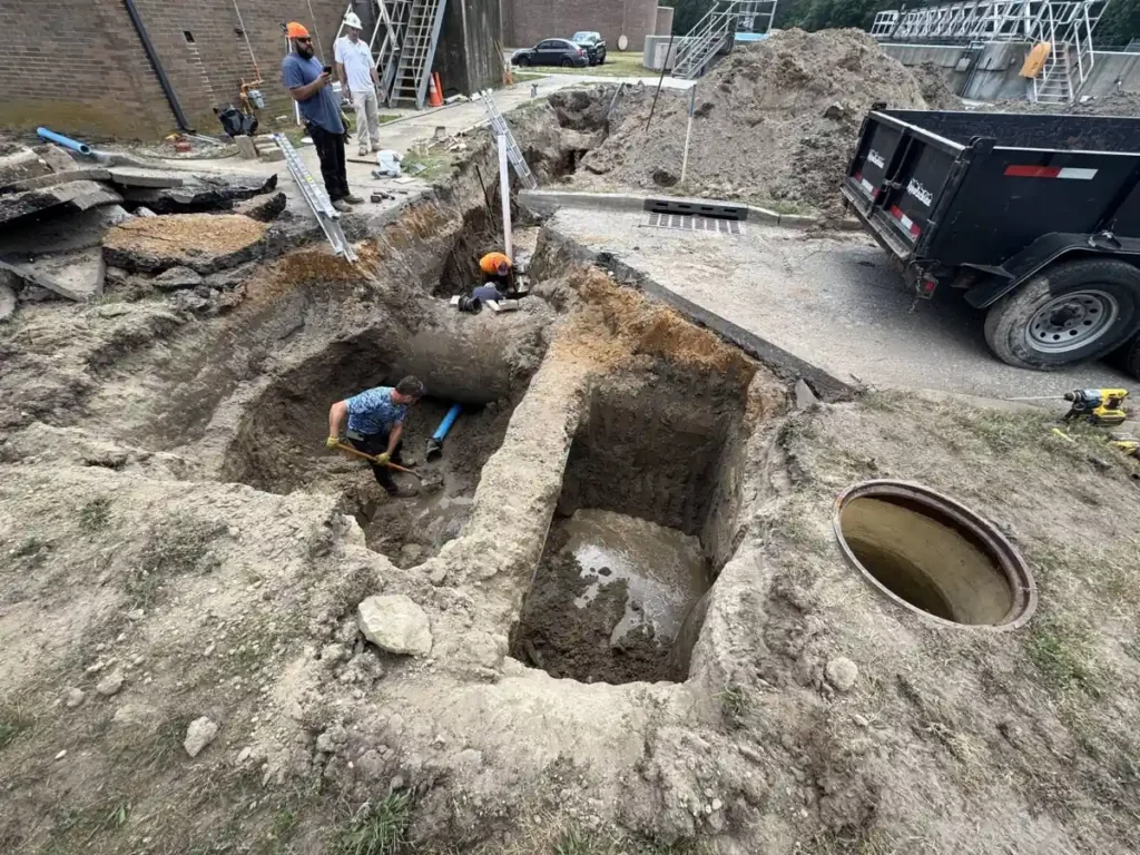Are Sewer Line Warranties and Service Plans Worth It for Evesham Homeowners? Crew working on an exposed sewer line in an open trench in Evesham, NJ