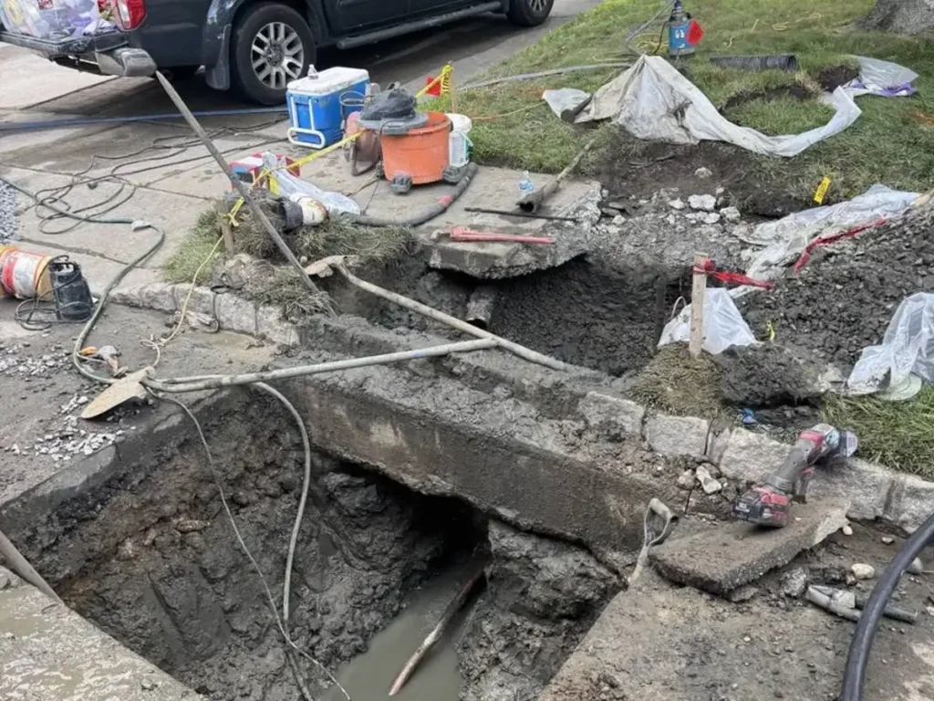 Sewer line dig opened at the driveway and curb of a home in Evesham, NJ